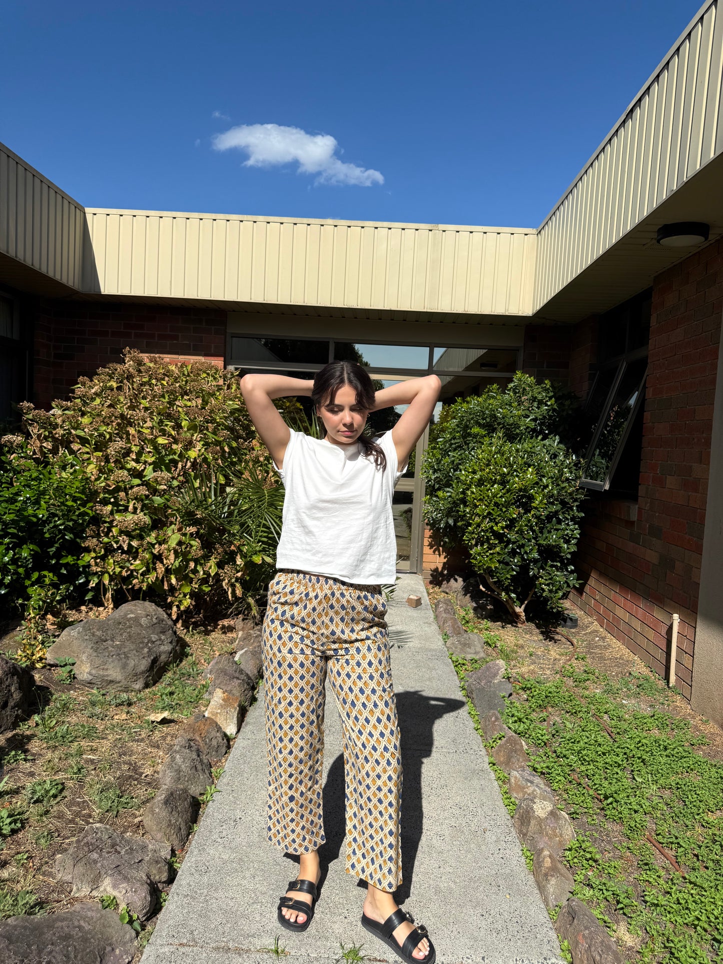 Neoma Indigo Sand cotton wide-leg pants worn outdoors in natural light