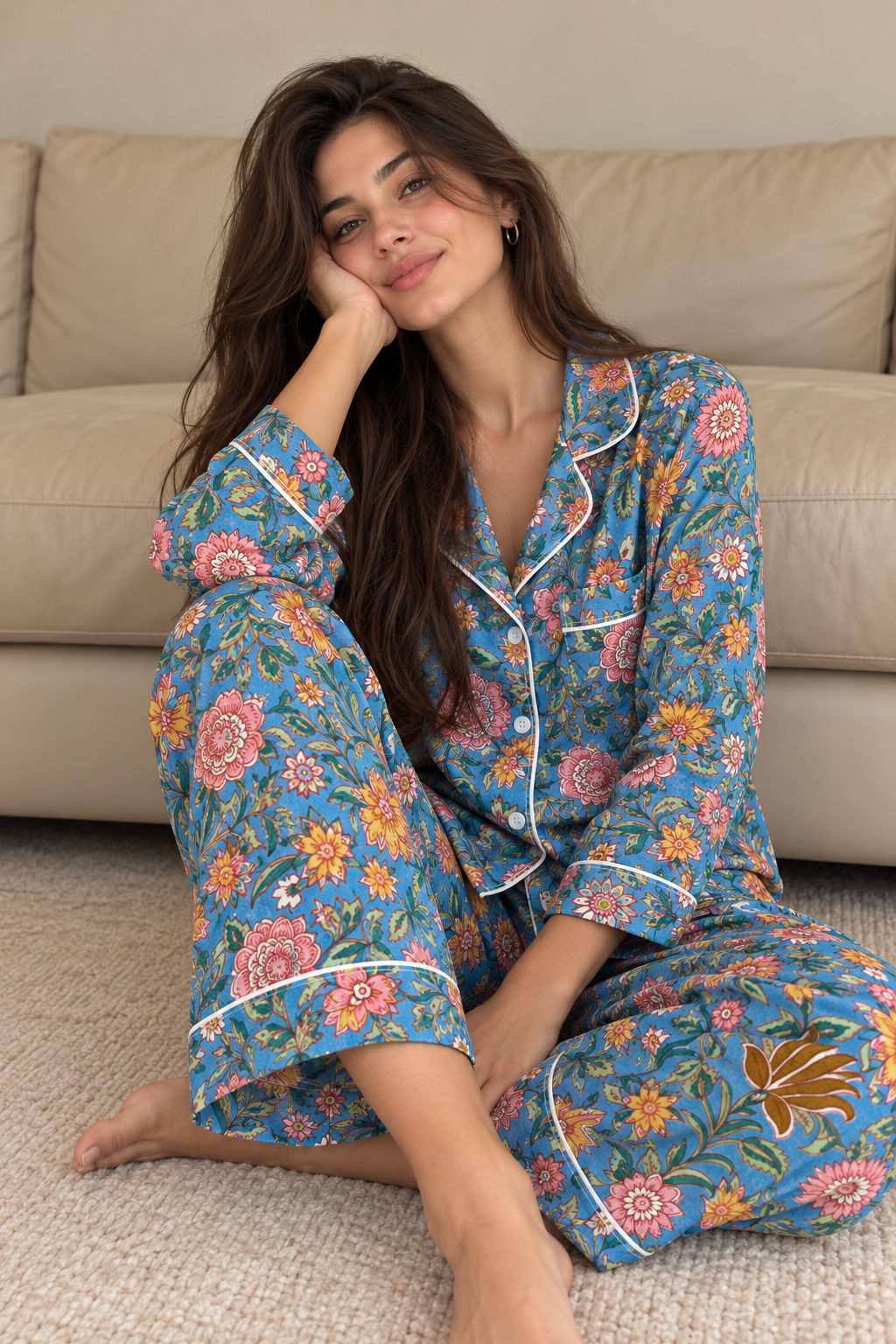 Woman wearing the Azure Garden blue floral cotton pyjama set with a piped button-up shirt, chest pocket and matching full-length pants.
